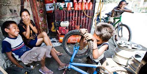 Boys in Dili, Timor-Leste, running a bicycle repair shop