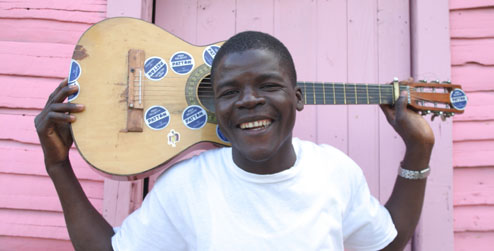 man holding guitar, Dominican 'batey'