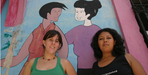 Two women outside women's rights organisation building in El Salvador