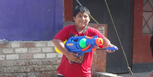 A boy in Peru during water carnival