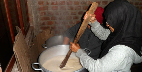 ICS volunteer Farah Hossain stirring a pot of milk