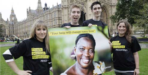 Young campaigners with a giant postcard for the UK Government