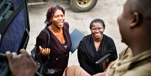 Development worker Teclah Ponde talks to a truck driver