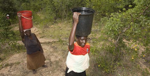 Women carrying buckets of water