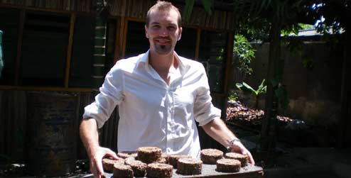 Nick Molyneux holding briquettes, sustainable fuel which he introduced to the local communities