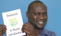 Innocent Ogaba holds a card from supporters in Hertfordshire