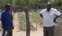 Development worker Cliff Maunze (right) with a farmer in Zimbabwe