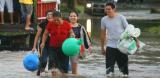People wading through flood water in San Francisco Menendez, El Salvador