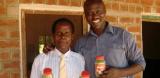 Innocent Ogaba and Mr Laston holding moringa jars