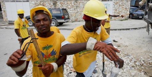Haitian workers clear rubble in streets of Port-au-Prince