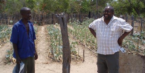 Development worker Cliff Maunze (right) with a farmer in Zimbabwe
