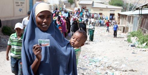 Somaliland woman holds ID card in queue to vote