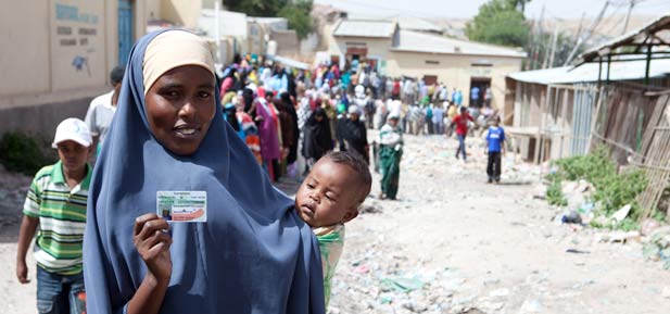 A woman in Somaliland holds up her ID card