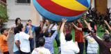 People holding up a coloured ball