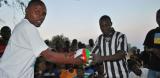 Two men holding a football in Malawi