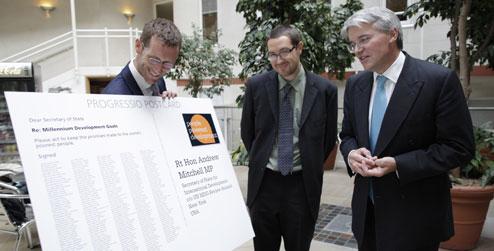 Giant postcard of MDG petition is presented to Andrew Mitchell MP