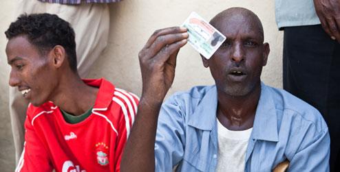 A man holds up his voter ID card in Somaliland