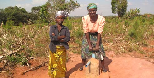 Dalesi tembo and Mercy Msiska by a water pump, Malawi