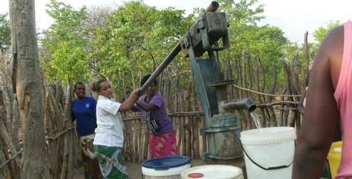 Volunteer pumping water 