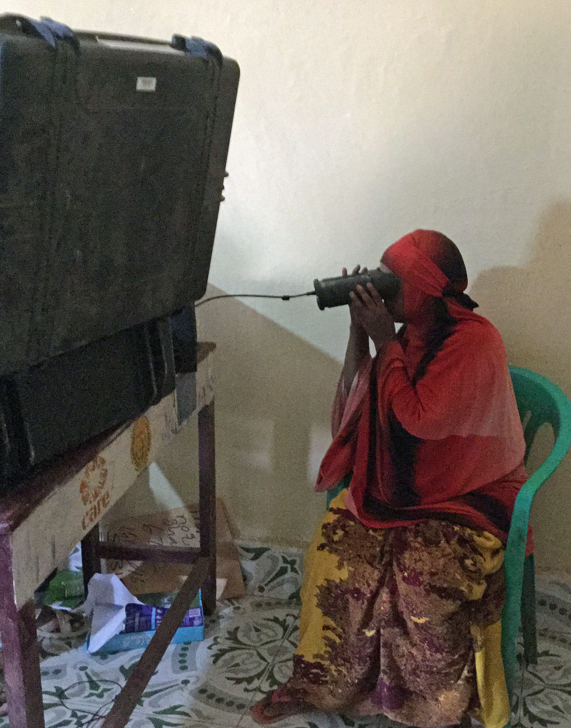 A female voter uses new iris-recognition technology 