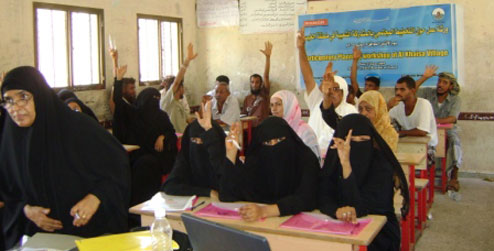 People put their hands up in a workshop in Aden