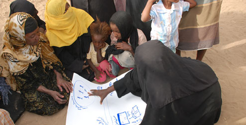 Women and children discussing community needs