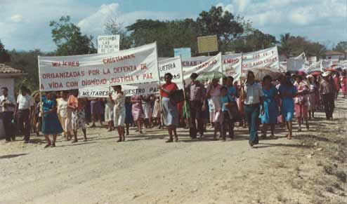 Women holding flags and marching in the streets of El Salvador