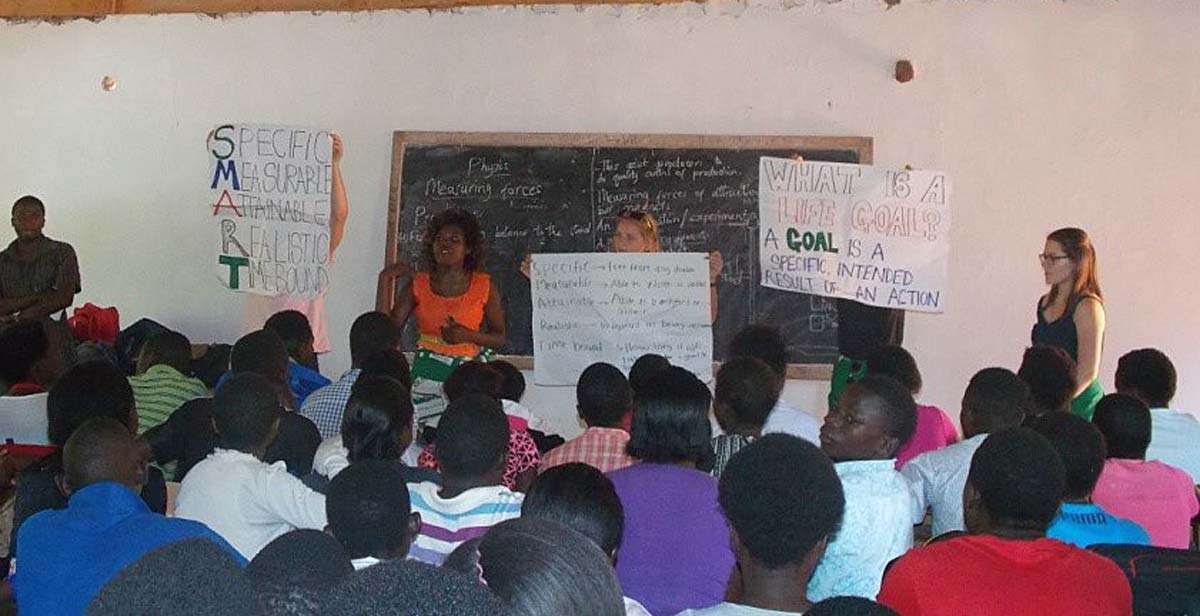 Volunteers delivering a session on life goals