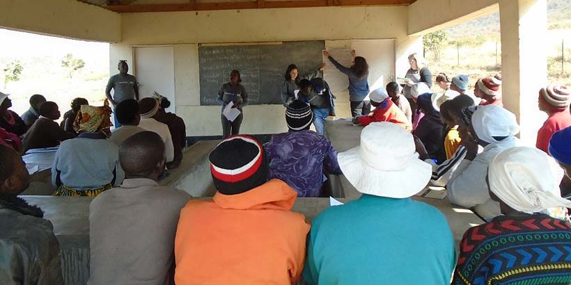 ICS volunteers delivering a session on ISALS to beneficiaries