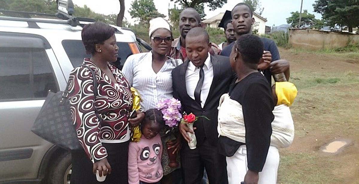 National Team Leader Raymond (in black suit) with his family