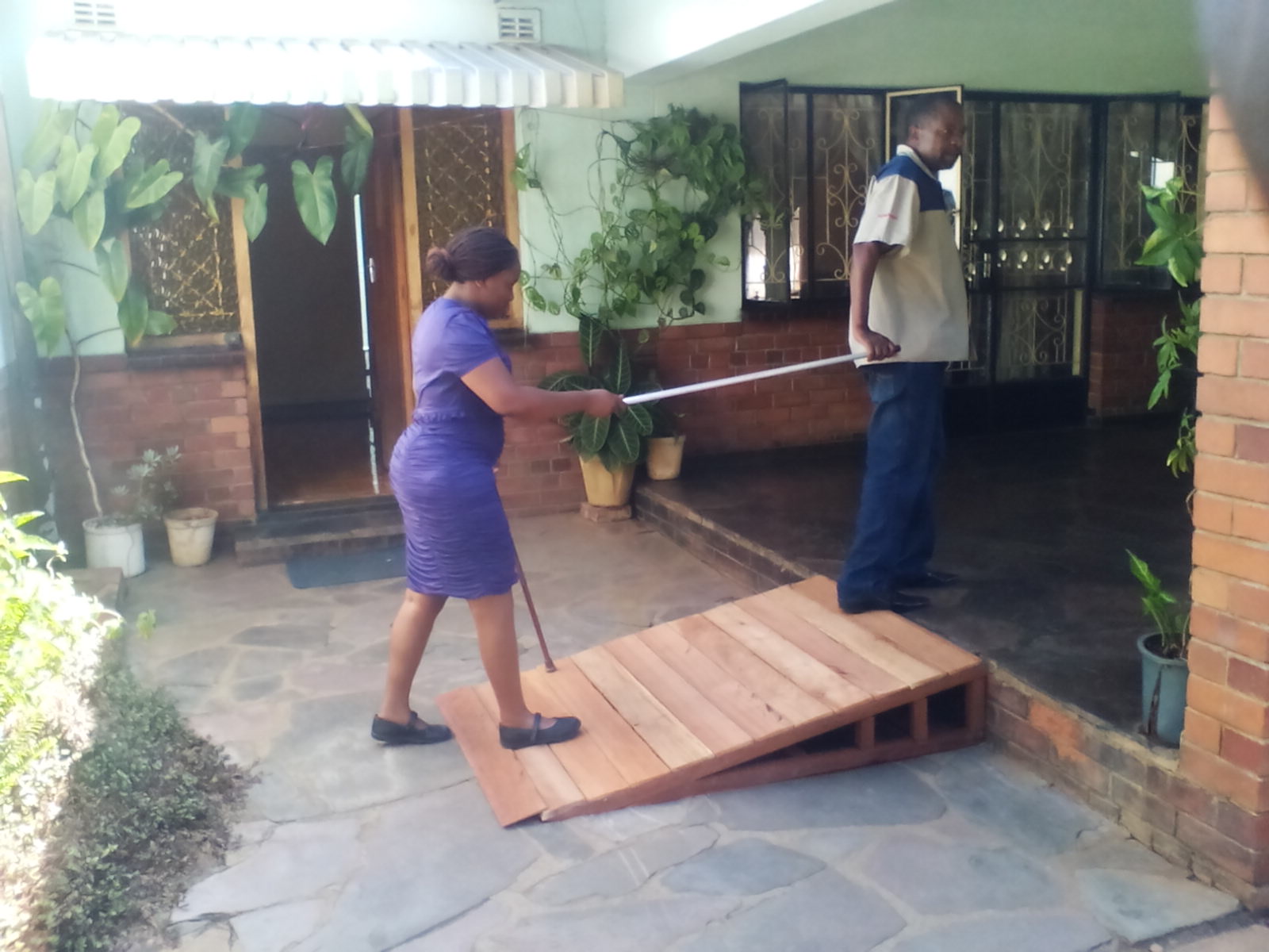 Farai with Yeukai Mazhawidza, who is living with HIV and who is learning to walk with a prosthetic leg