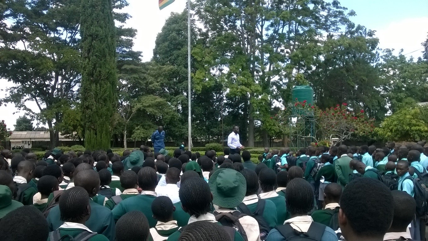 A man presents to a large crowd of school pupils