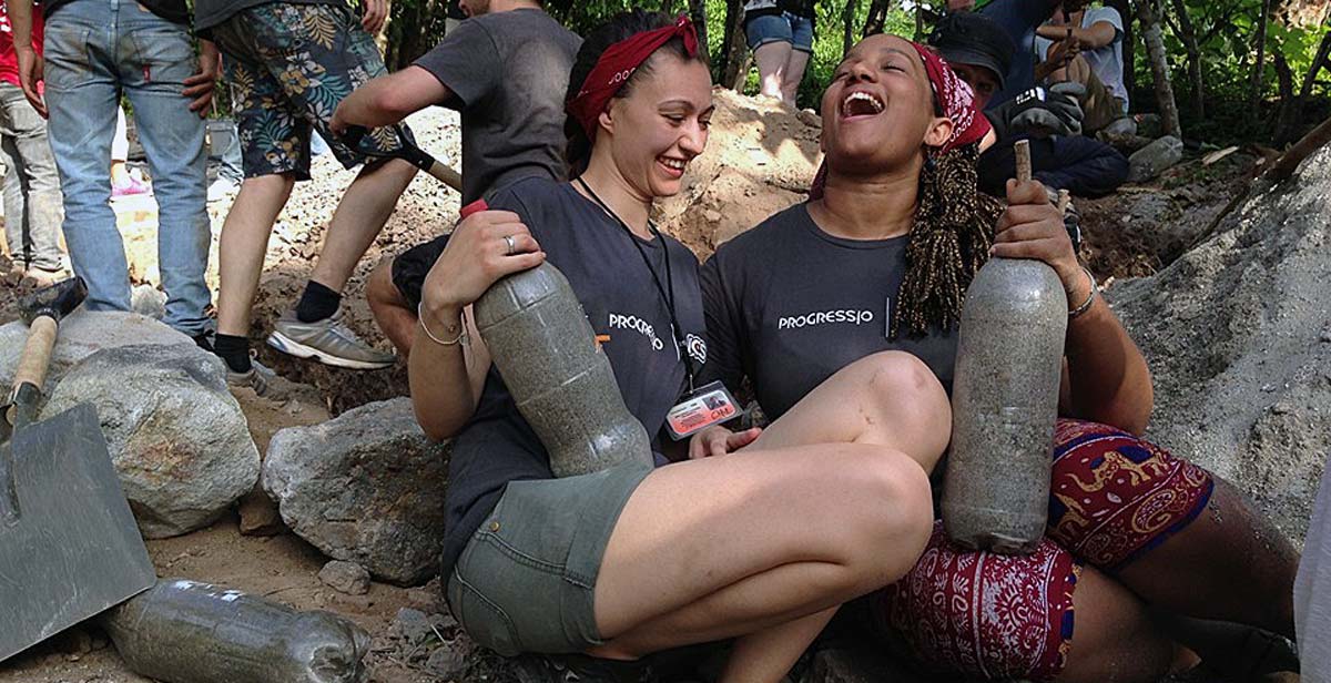 Volunteers making bio-bricks using recycled plastic bottles