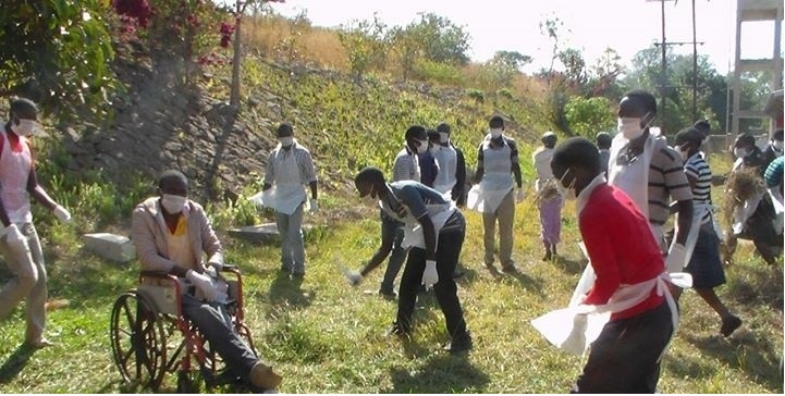 Local volunteers help to clean up their hospital in Malawi