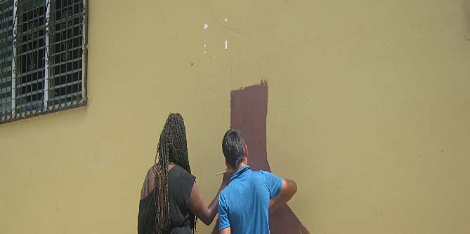 Francis and I painting the trunk of the mural