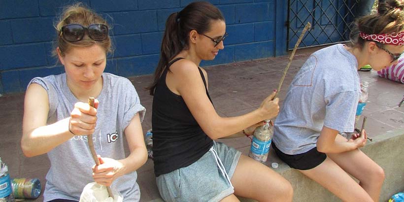 Volunteers recycling bottles to make bins