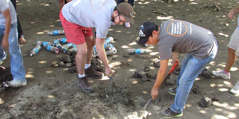 Volunteers mixing cement for the bins