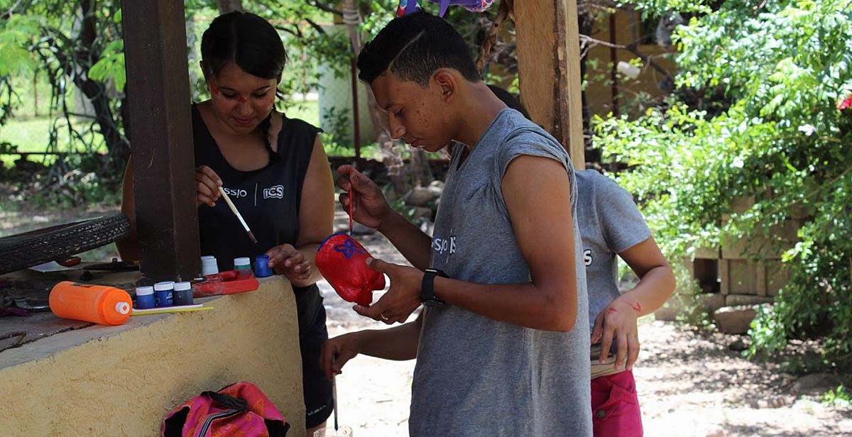 Volunteers painting plastic bottles