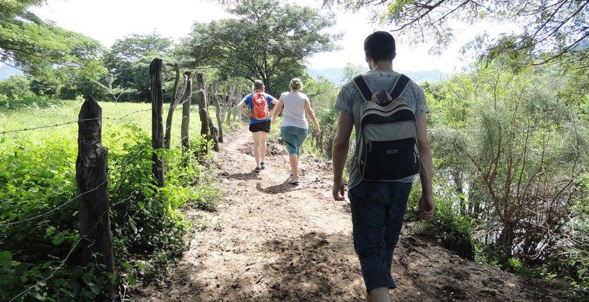 Volunteers walking alongside the river