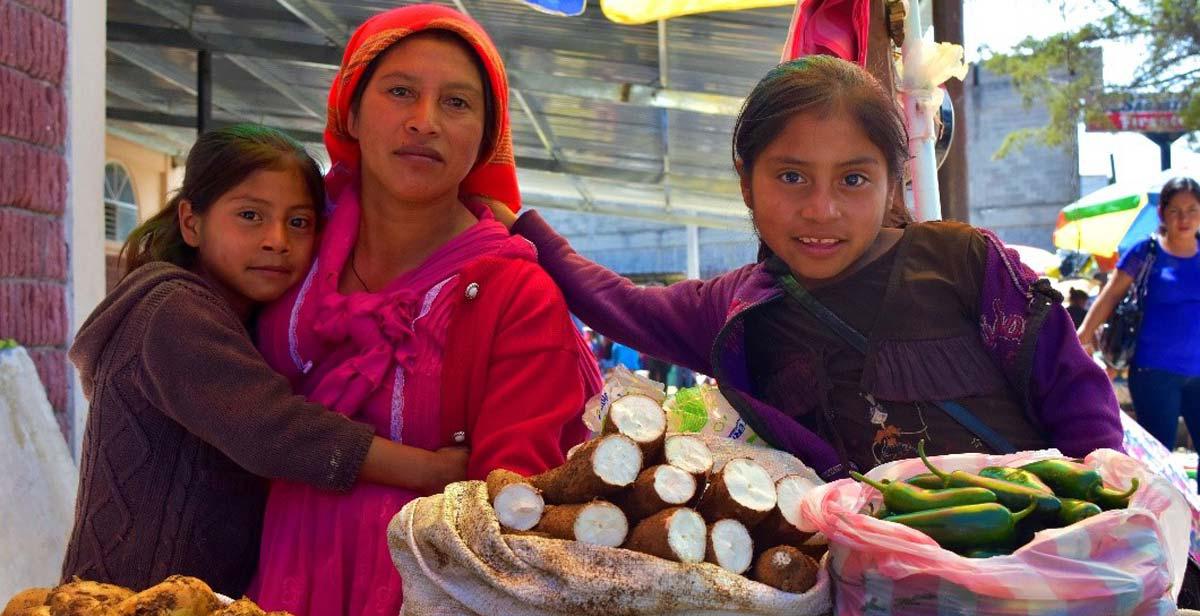 A Lenca woman and her two daughters selling their produce at a market in La Esperanza
