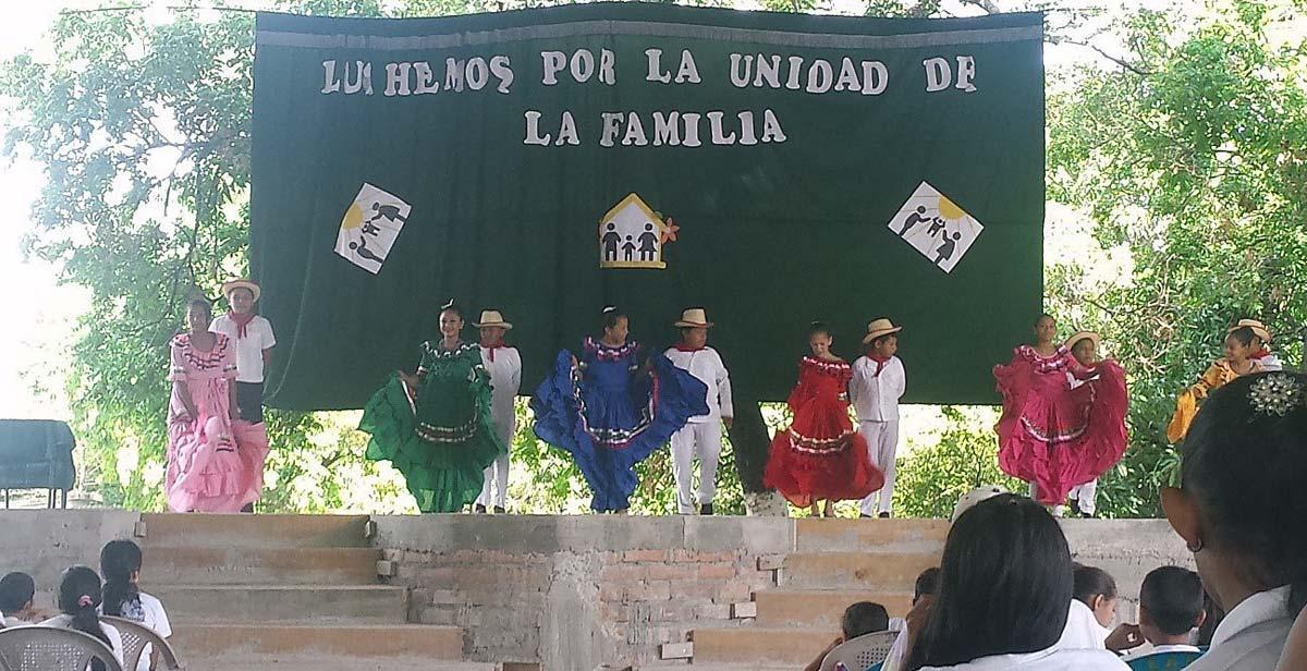  Children dancing a folkloric dance on stage for parents, teachers, and fellow pupils