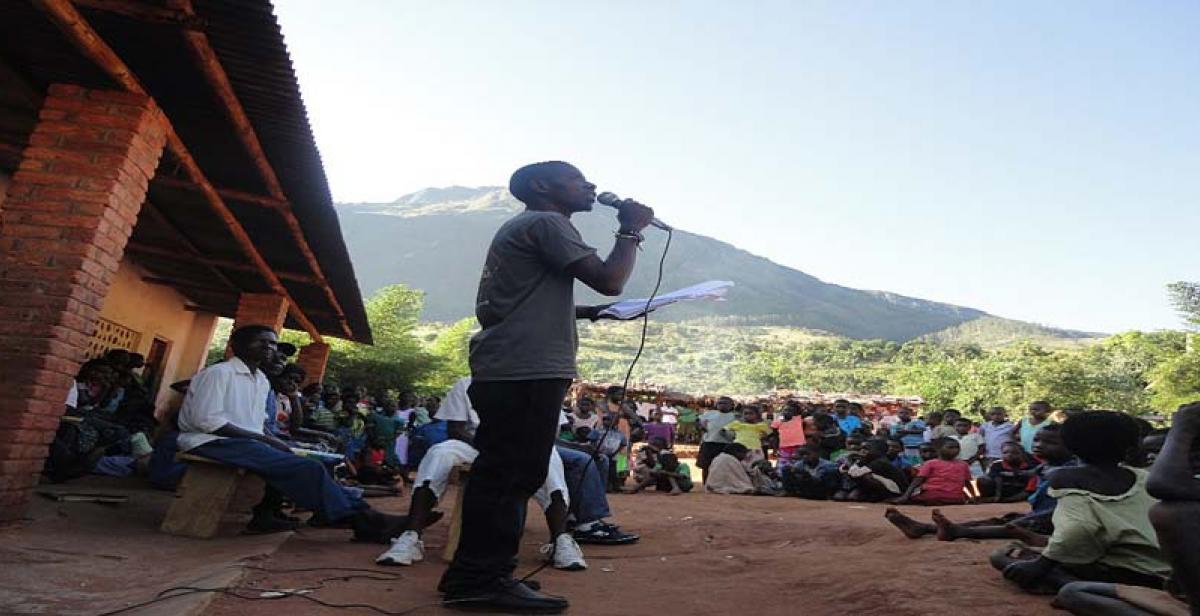  An ICS volunteer giving a speech about the importance of Labour Day