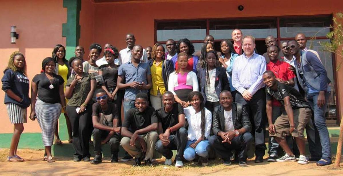 Smiling faces of participants during the Alumni Conference captured outside the venue for the event