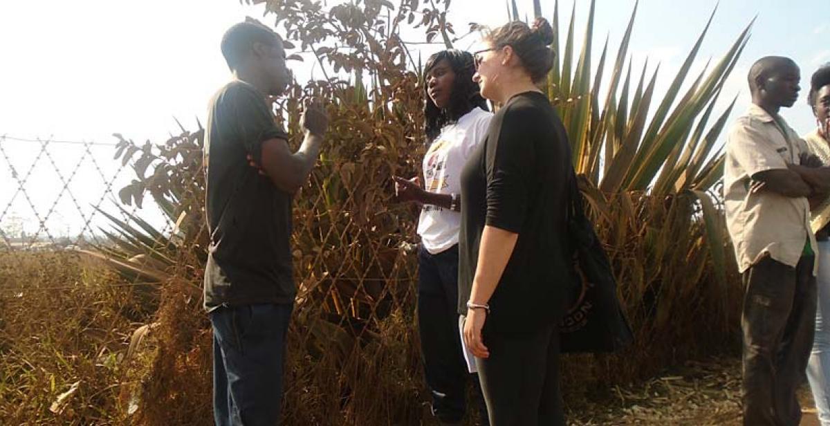 Sally and Mercy discussing sexual reproductive health services with a bicycle taxi operator