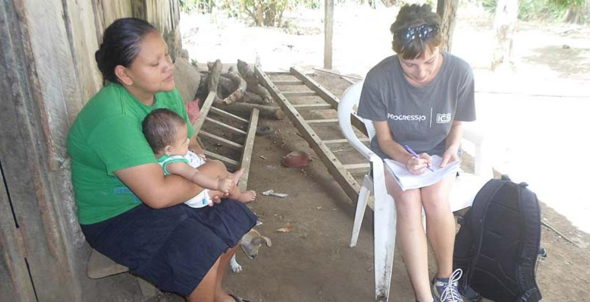 An ICS volunteer surveying community members