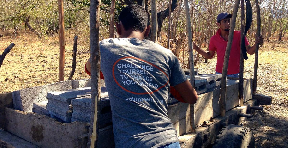 Volunteers helping the beneficiaries pick up their materials