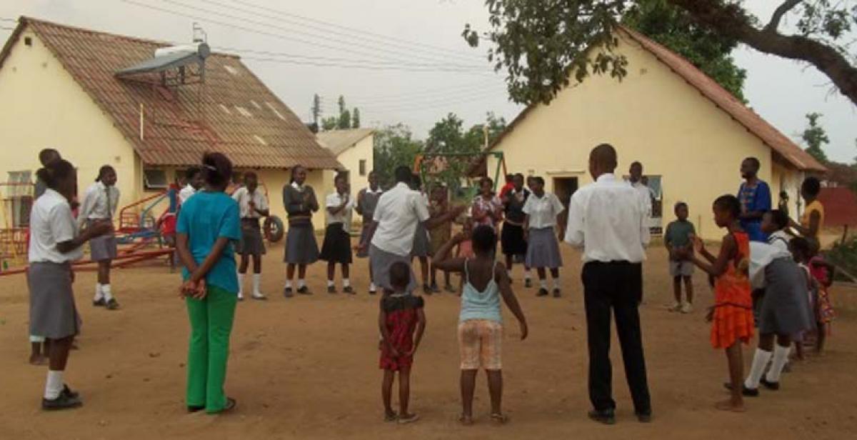 Visiting school children play games with the orphans at Mushawevana 