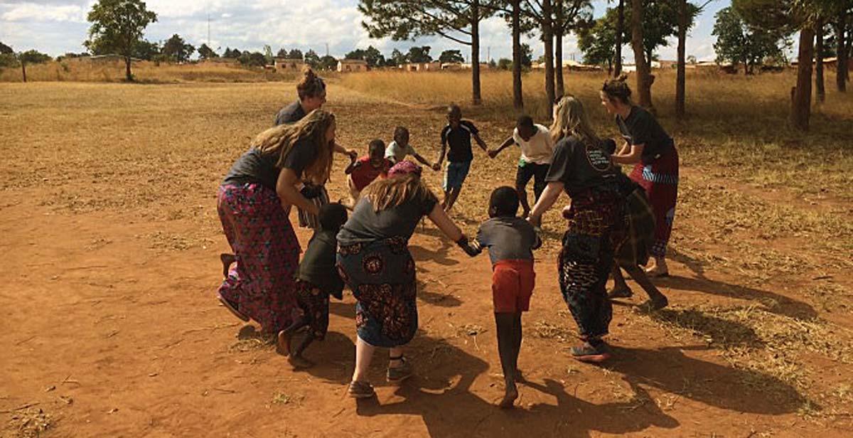 UK volunteers playing and singing songs with the children in Champhira 