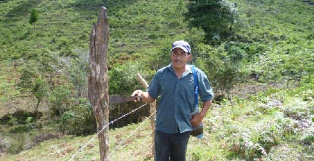 Agustin standing beside fence
