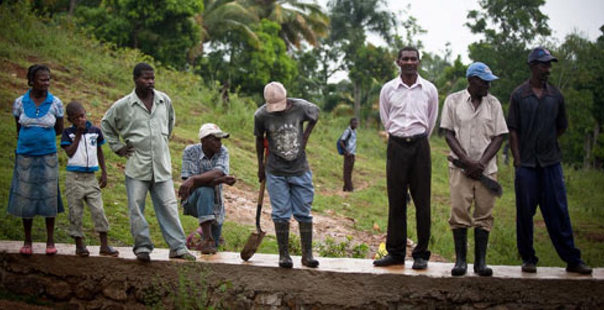 Villagers in Lamine Haiti standing on flood wall